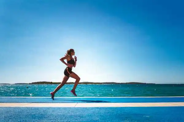 Woman running showing strong leg muscle Robroyston